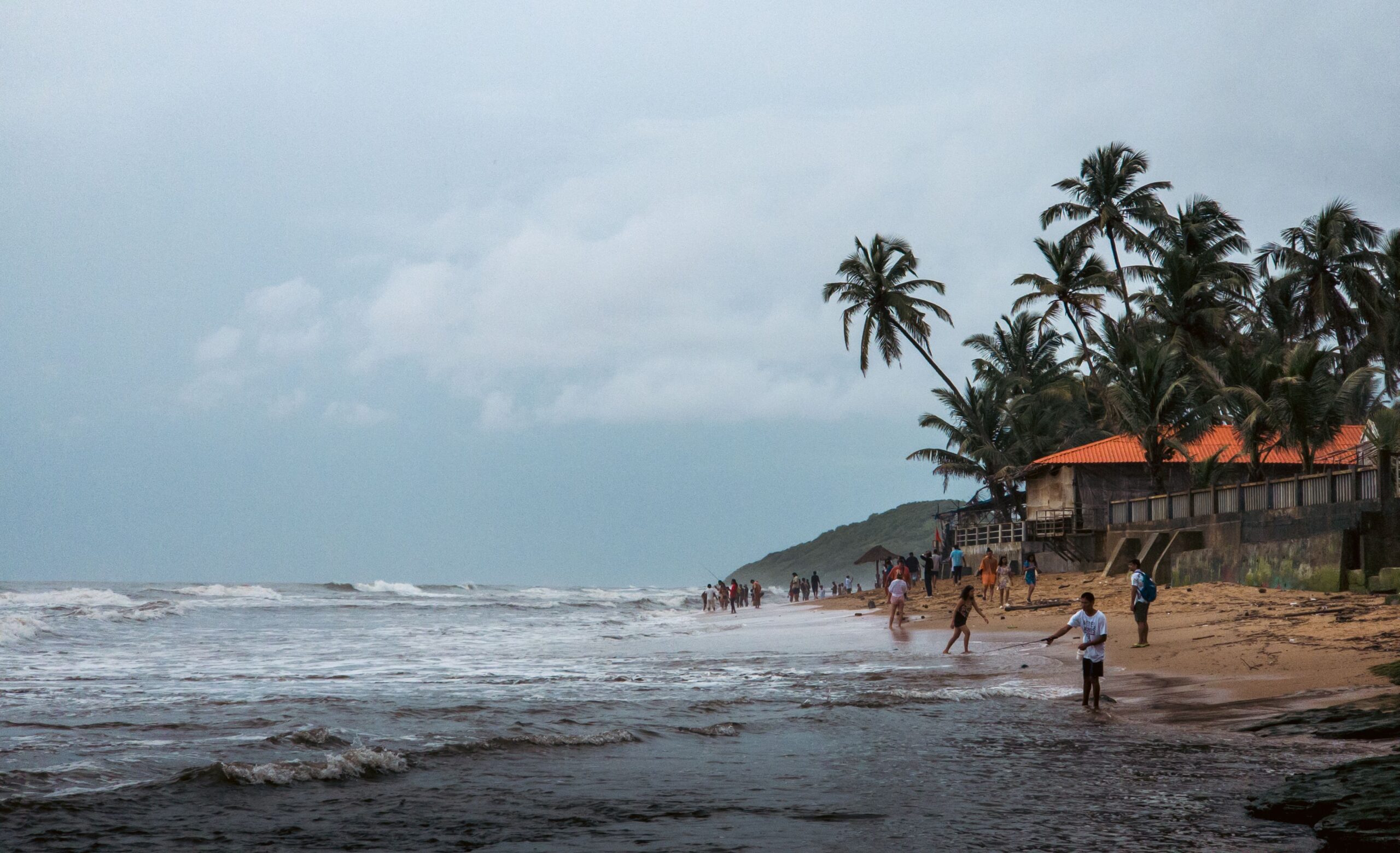 Tourists enjoying a scenic beach in Goa during an affordable coastal vacation.